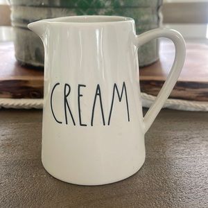 Rae Dunn “Cream” pitcher. Small chip on the bottom lip. See photo.